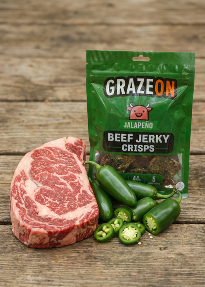 GrazeOn jalapeno beef jerky crisps packaging with a steak and jalapenos on a wooden surface